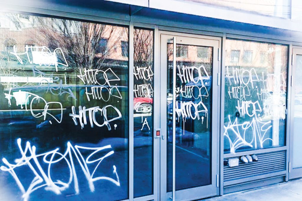 Commercial Window Film 9 A shop front in the USA with graffiti on the glass that has anti-graffiti window film